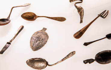 Various, metal cutlery pieces on a white background.